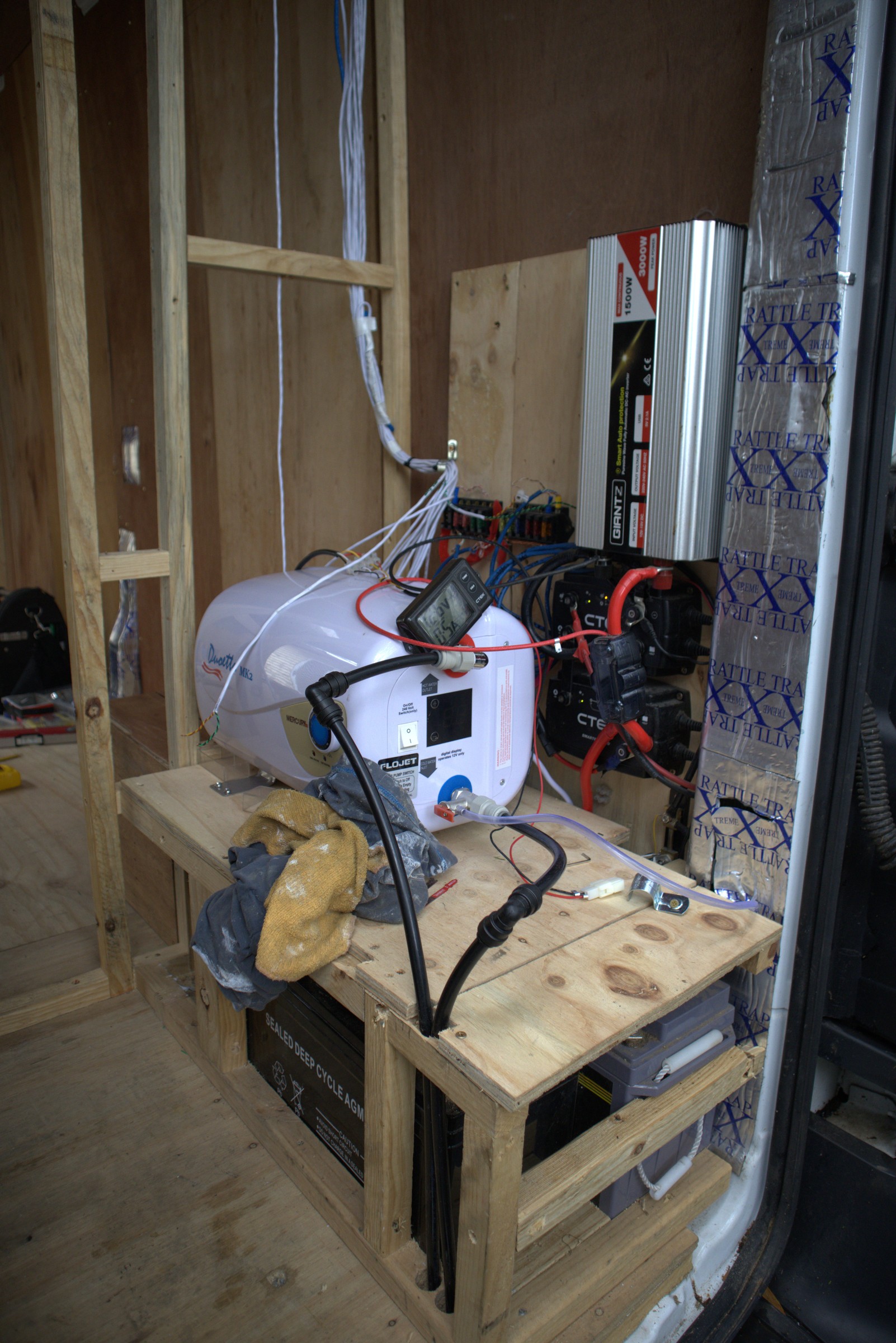 Garage electrical installation in Jared's van build, showing inverter, battery and wiring