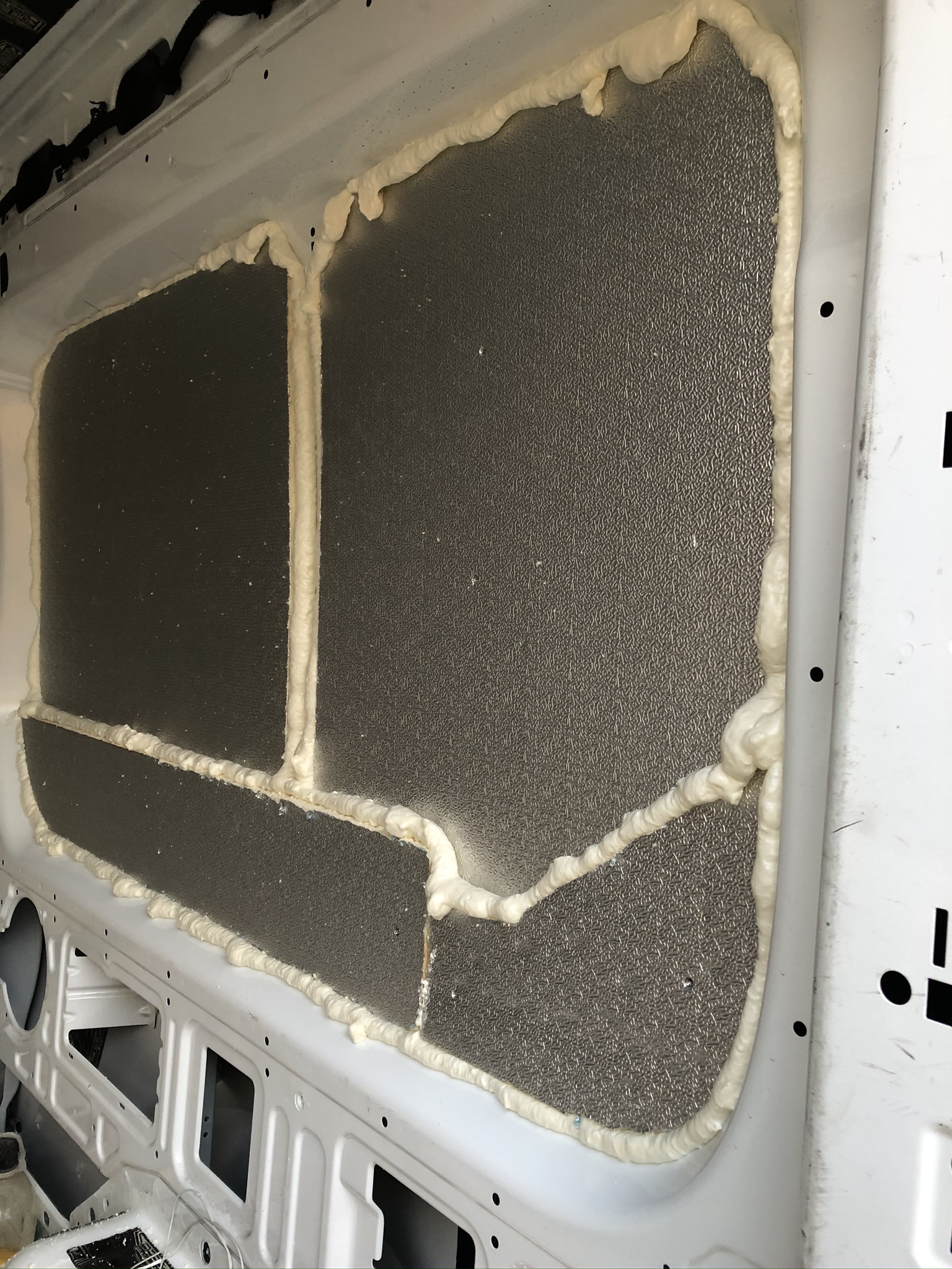 Double-sided foil insulation going in during my second van build